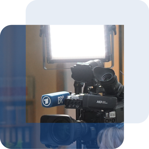 Eine Fernsehkamera mit Mikrofon des Bayerischen Rundfunks vor einer Studioleuchte
